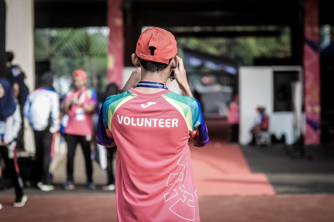A volunteer in a bright jersey at a community event.