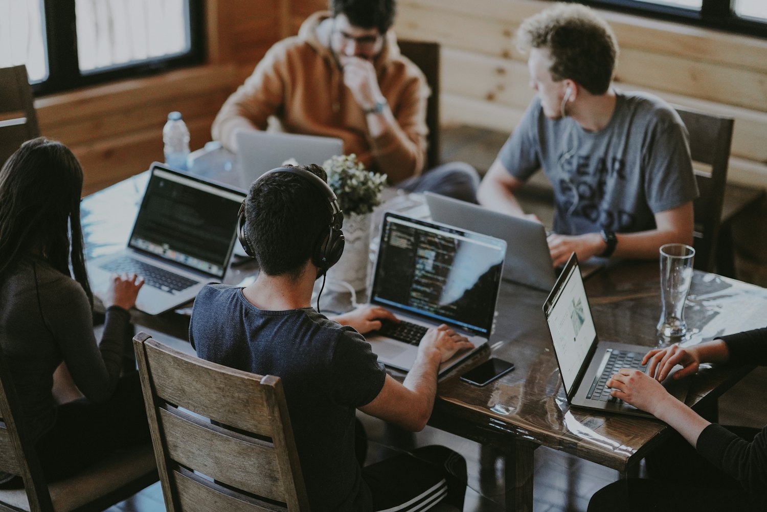 A marketing team collaborating around laptops