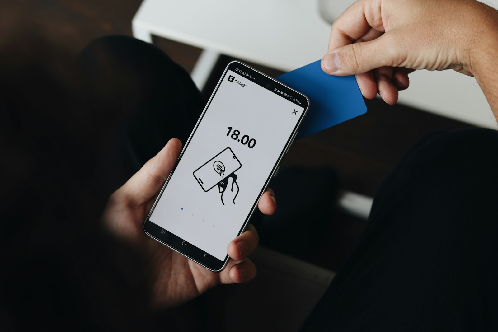 Small business owner using a smartphone, illustrating the mobile-first reality of a homepage above the fold