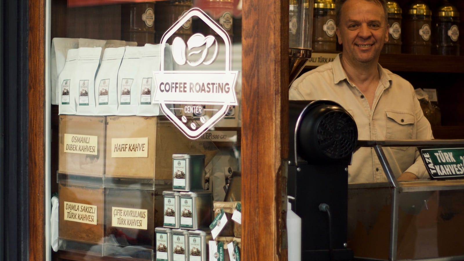 Quad Cities small business owner standing at the counter of a coffee shop, the kind of operator who runs an email list and just got squeezed by mailchimp alternatives small business pricing changes