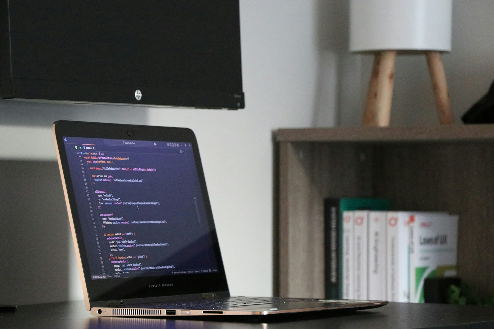A laptop on a desk showing code, representing the true cost of Wix and Squarespace versus a custom WordPress build