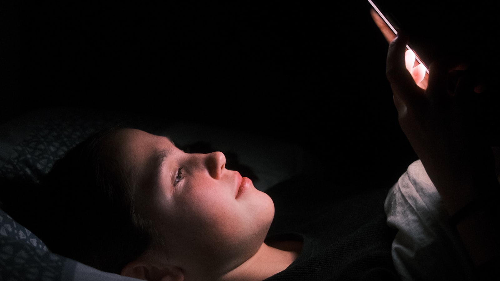 Customer browsing on a phone at night, when online booking for small business wins the appointment