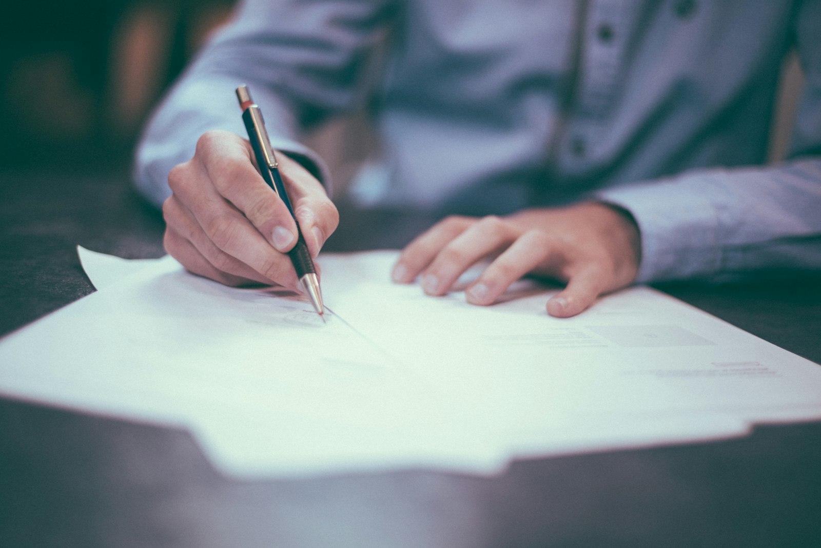 Small business owner reviewing a pay monthly website design contract before signing