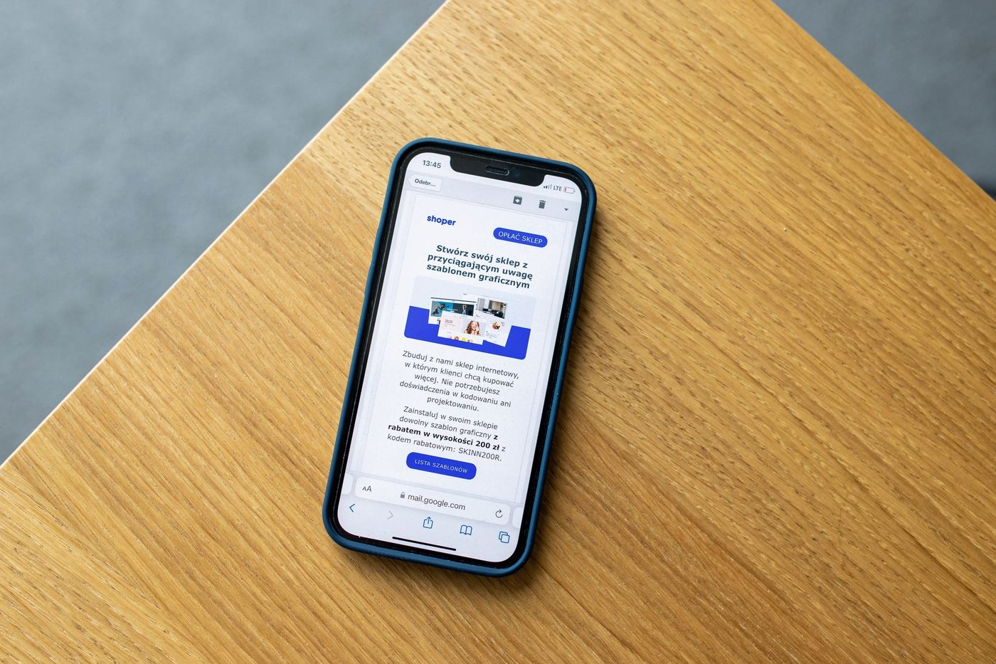 Smartphone on a wooden table displaying an email newsletter