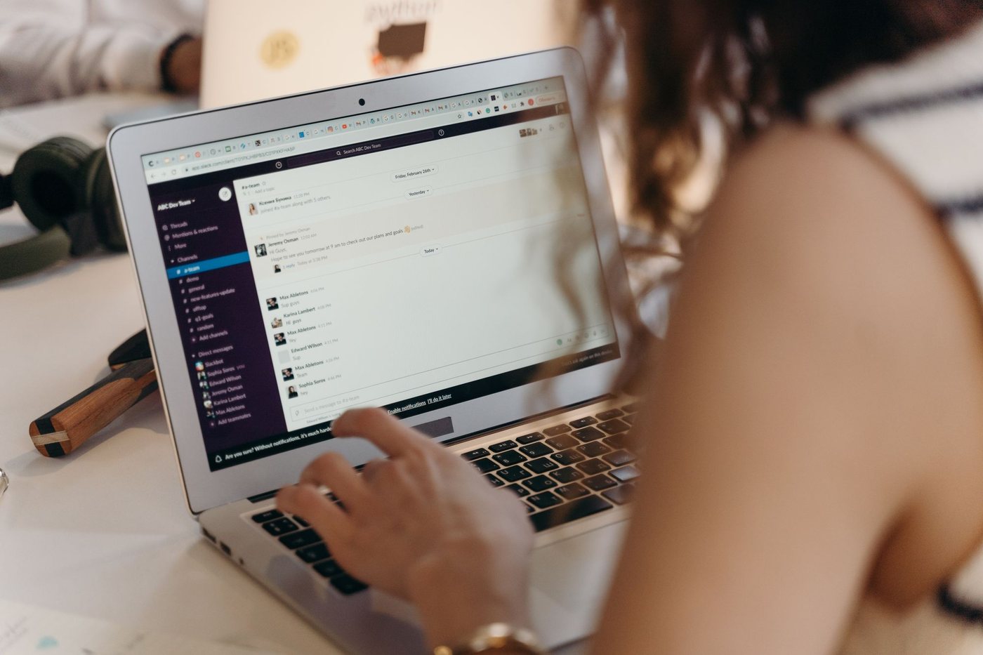 Person reading an email inbox on a laptop at a desk