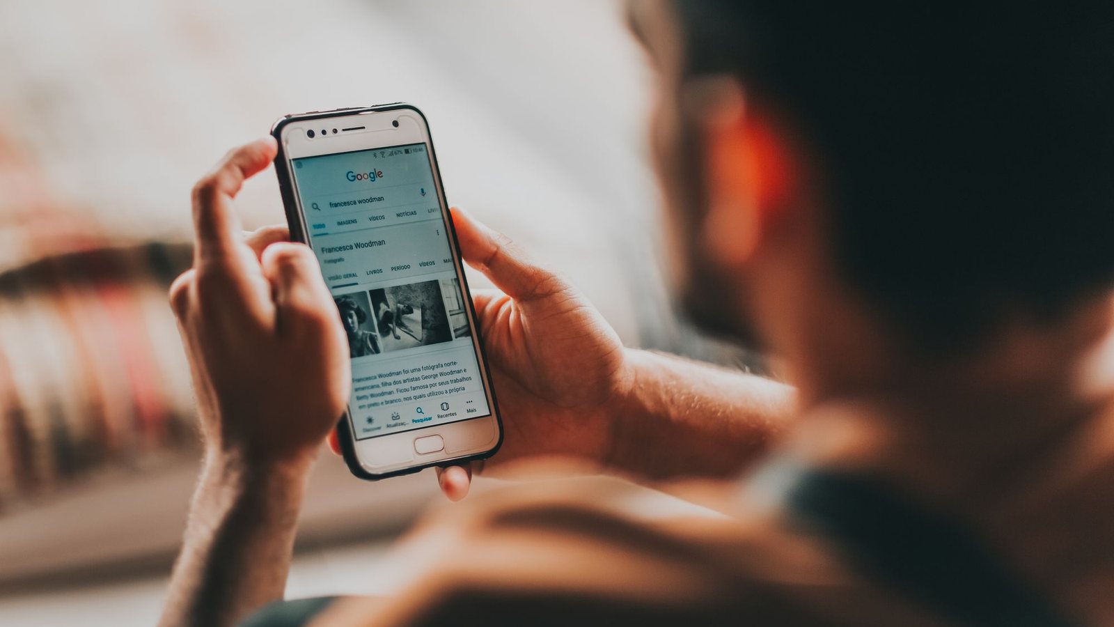 Person scrolling a business website on a smartphone